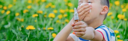Children's allergy to flowers. Boy on a background of dandelions, allergy, sneezing.の写真素材