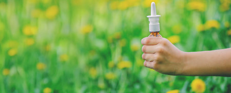 Children's allergy to flowers. Boy on a background of dandelions, allergy, sneezing.の写真素材