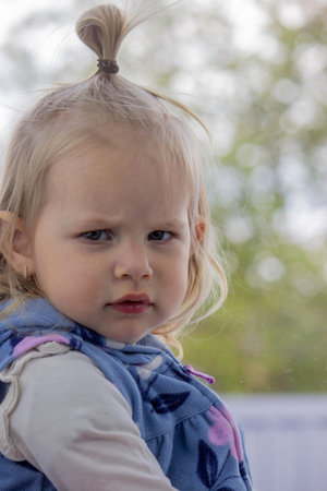 Close-up of a small child's face and nose. Cold, runny nose in children, allergies.