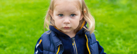 Close-up of mucus flowing from the nose of a little girl. Child has a runny nose. Selective focus.の写真素材