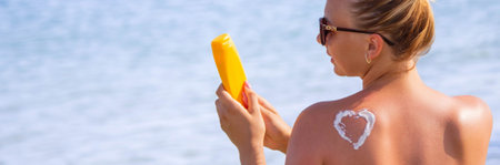 girl on the background of the sea with suntan cream. Selective focus.