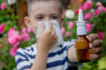 Child Sneezing from Flower Allergy. Selective focus.の写真素材