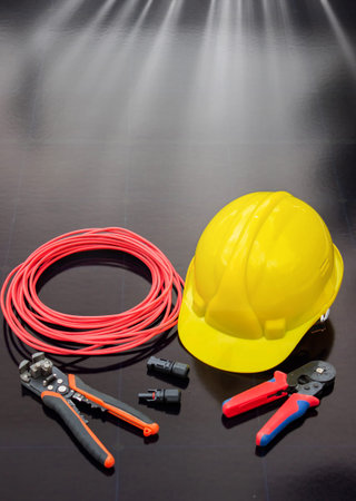 Solar Installation Tools and Safety Equipment on Solar Panel Surface.