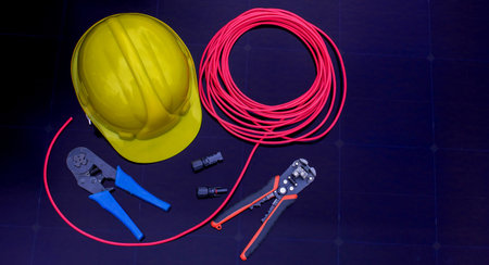 Solar Installation Tools and Safety Equipment on Solar Panel Surface.