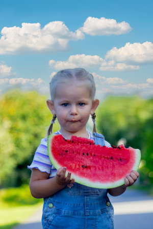 Happy child eating watermelon. Summer.の写真素材