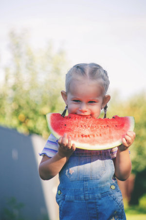 Happy child eating watermelon. Summer.の写真素材