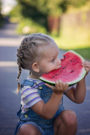 Happy child eating watermelon. Summer.の写真素材