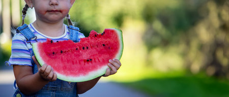 Happy child eating watermelon. Summer.の写真素材