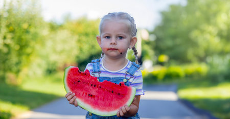 Happy child eating watermelon. Summer.の写真素材