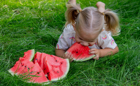 Happy child eating watermelon. Summer.の写真素材
