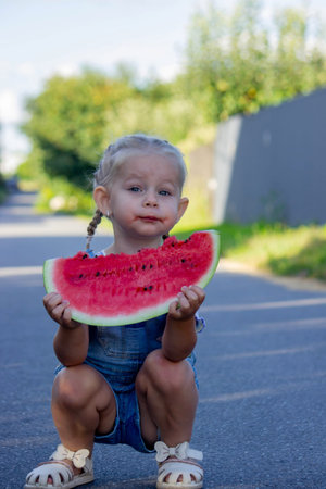 Happy child eating watermelon. Summer.の写真素材