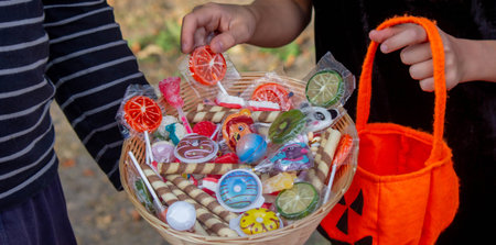 Children collecting candy for Halloween. Selective focus.の写真素材