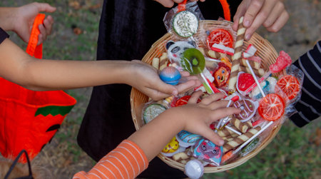 Children collecting candy for Halloween. Selective focus.の写真素材