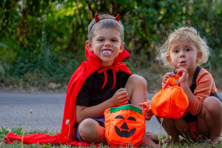 Children collecting candy for Halloween. Selective focus.の写真素材
