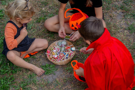 Children collecting candy for Halloween. Selective focus.の写真素材