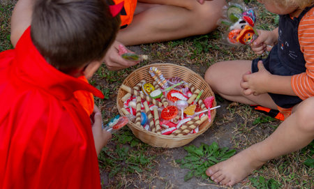 Children collecting candy for Halloween. Selective focus.の写真素材