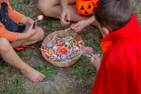 Children collecting candy for Halloween. Selective focus.の写真素材