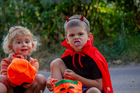 Children collecting candy for Halloween. Selective focus.の写真素材
