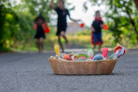 Children collecting candy for Halloween. Selective focus.の写真素材