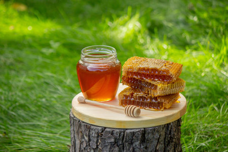 fresh honey on a background of garden and flowers. Selective focus.の写真素材