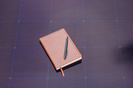 Notebook with Pen on Solar Panel.の写真素材