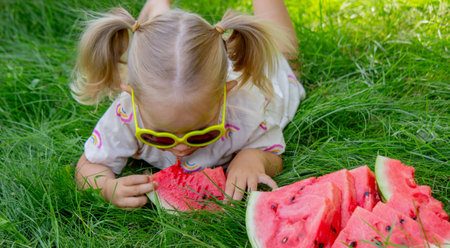 Little girl eating watermelon. Selective focus.の写真素材