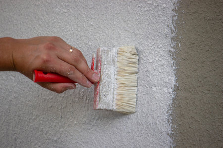 Painting a Wall with Brush and White Paint.の写真素材
