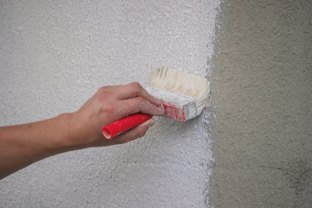 Painting a Wall with Brush and White Paint.の写真素材