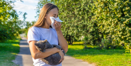 Woman holding a cat. Woman is allergic to cats. Allergy to cat furの写真素材