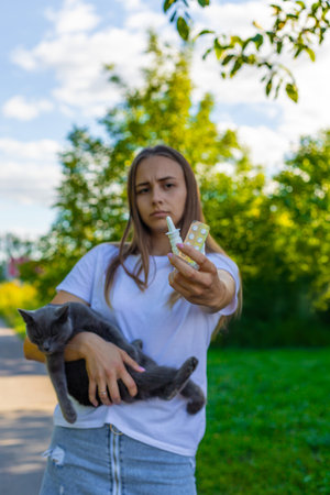 Woman holding a cat. Woman is allergic to cats. Allergy to cat furの写真素材