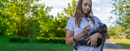 Woman holding a cat. Woman is allergic to cats. Allergy to cat furの写真素材