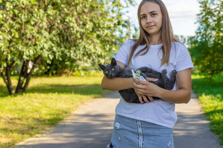 Woman holding a cat. Woman is allergic to cats. Allergy to cat furの写真素材