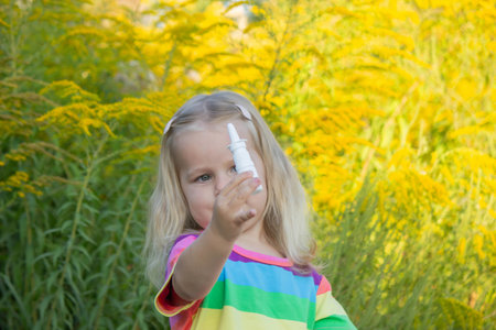 Girl in rainbow shirt with ragweed allergy.の写真素材
