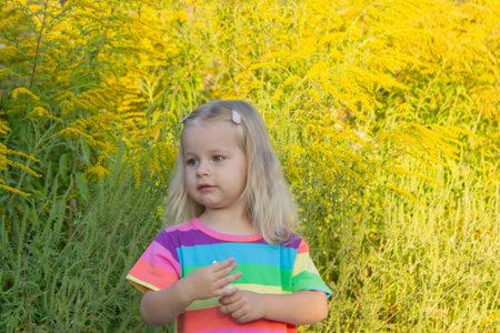 Girl in rainbow shirt with ragweed allergy.の写真素材