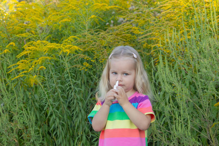 Girl in rainbow shirt with ragweed allergy.の写真素材