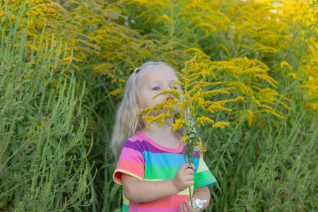 Girl in rainbow shirt with ragweed allergy.の写真素材