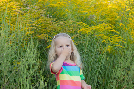 Girl in rainbow shirt with ragweed allergy.の写真素材