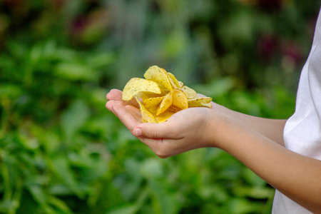 Boy eating chips. Food concept.の写真素材
