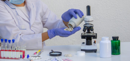 Pharmaceutical Research: Lab Technician Working with Medicine and a Microscope.