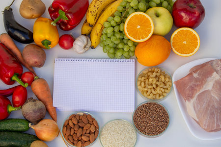 Healthy Meal Planning: Notebook for Recipes Surrounded by Fresh Produce.の写真素材