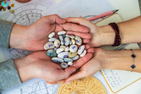 Numerology and divination with number stones in hands. Esotericism.の写真素材
