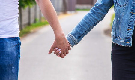 The lovers walk together holding hands. Selective focus. Nature.の写真素材