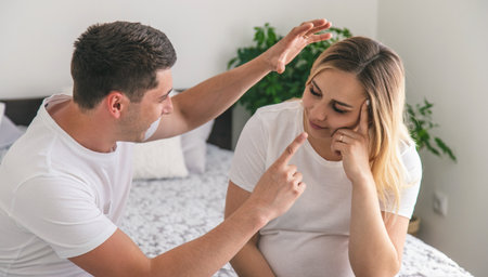 man scolds a pregnant woman. Selective focus. Home.の写真素材