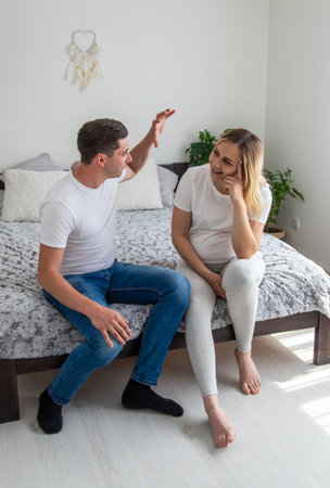 man and a pregnant woman. Selective focus. Home.