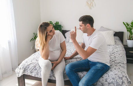 man scolds a pregnant woman. Selective focus. Home.の写真素材