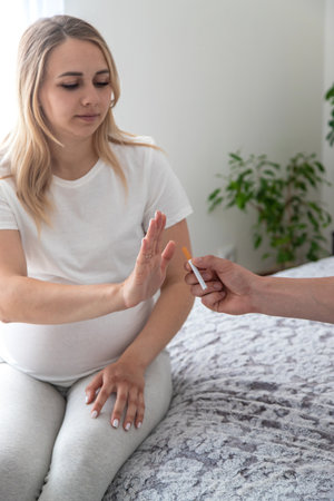 The pregnant woman refuses to smoke. Selective focus. Home.の写真素材
