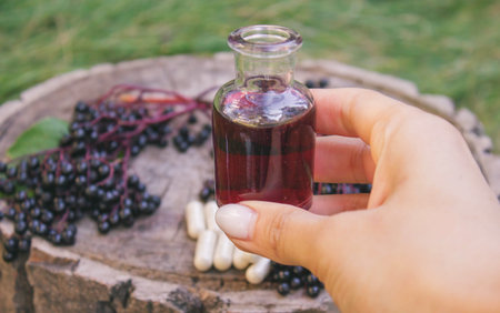 Elderberry berries, syrup, and herbal supplement capsules for natural cold and flu remedy