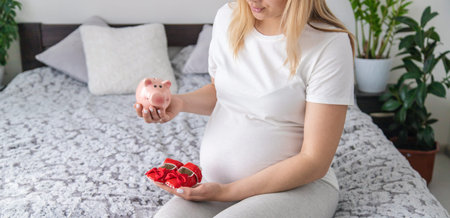 A pregnant woman holds a pig bank in her hands. Selective focus. People.