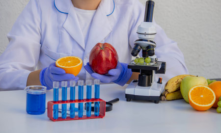 Female scientist checking fresh fruit quality in science laboratory.