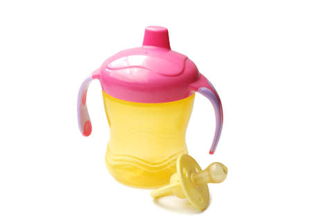 Yellow baby bottle with pacifier a white backgroundの写真素材